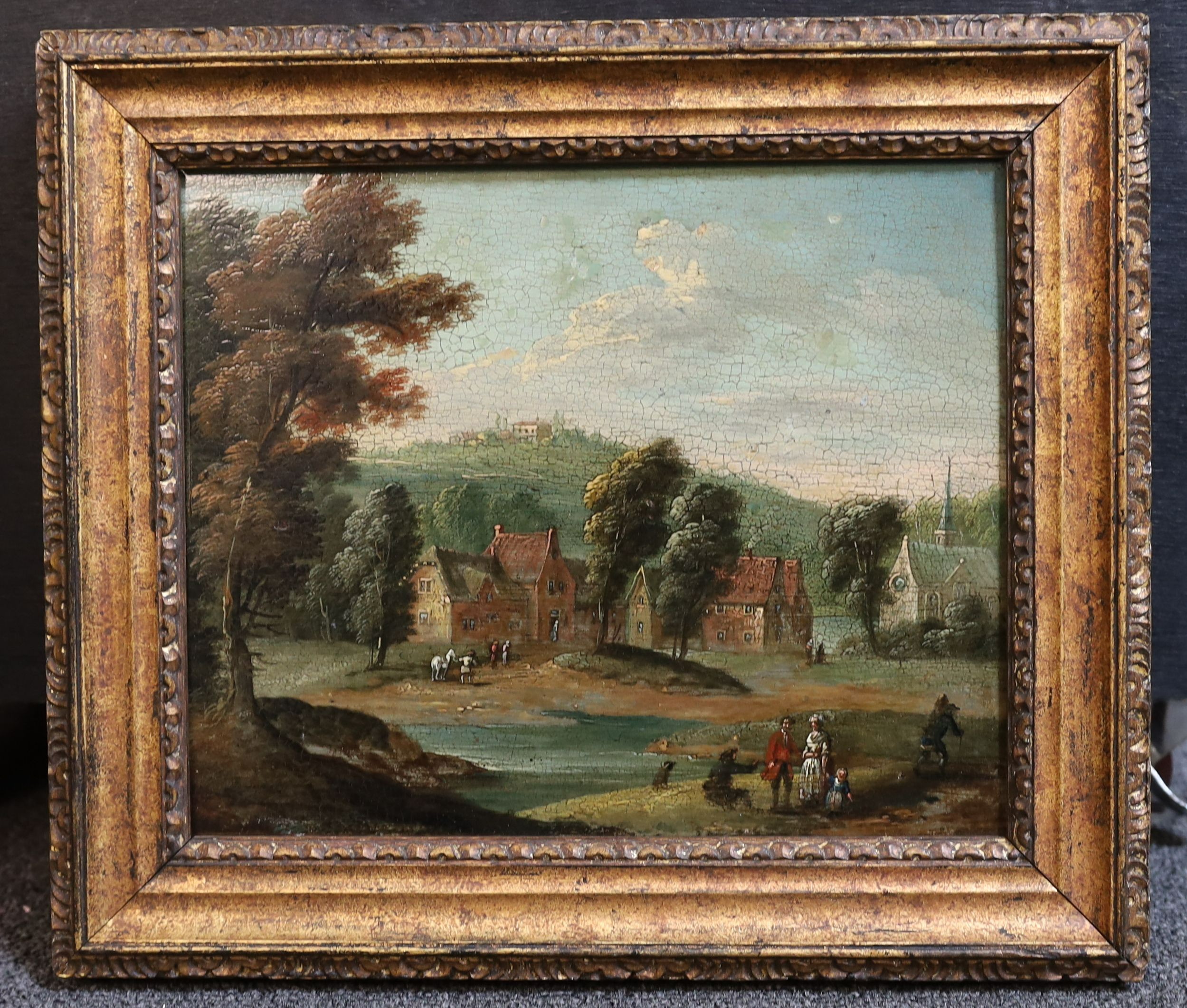 Follower of Jacob Salomonsz van Ruysdael (Dutch, 1629-1682), Figures in a landscape with houses and church beyond, oil on wooden panel, 20 x 24cm